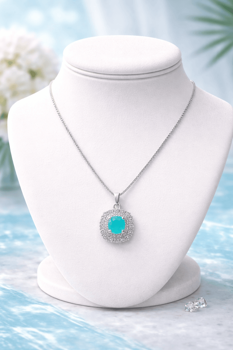 Necklace with a turquoise pendant on a white mannequin bust against a light blue background.