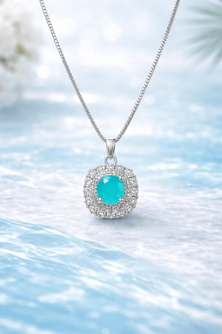 Silver necklace with a turquoise pendant on a light blue background