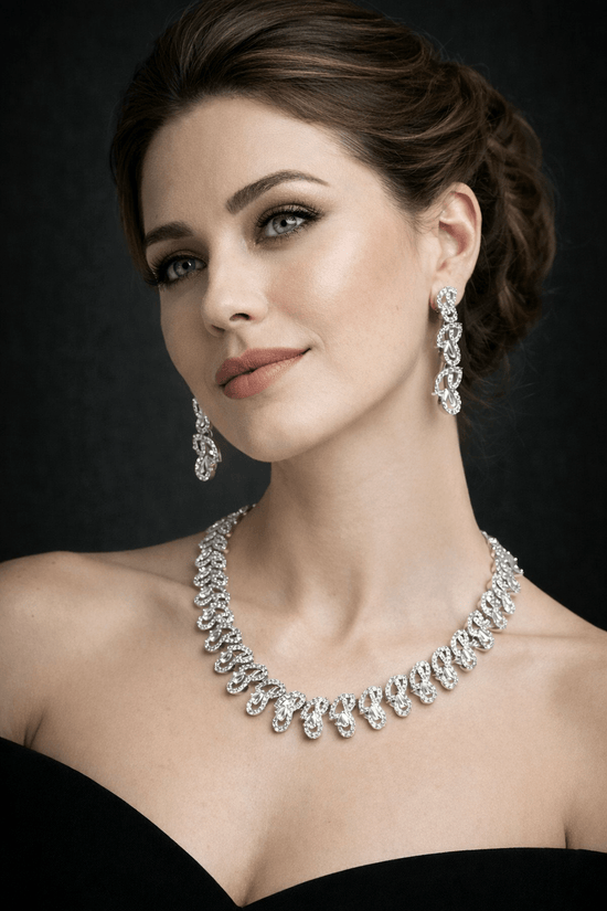 Woman wearing a diamond necklace and earrings against a dark background