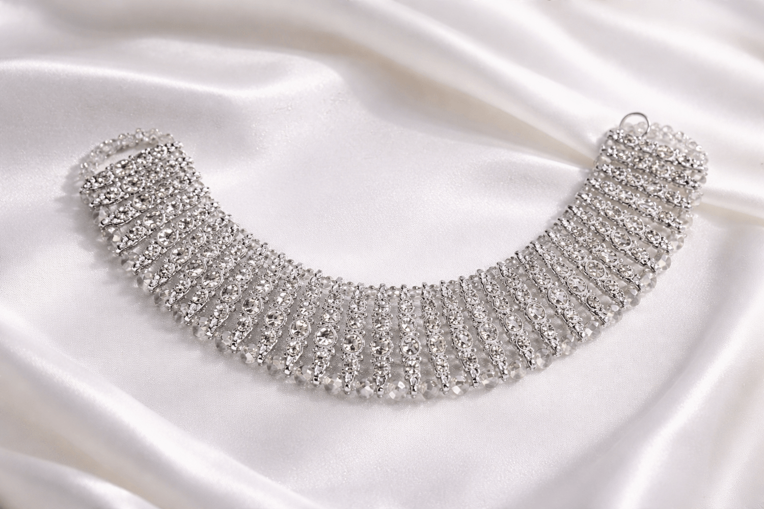 Silver necklace on a satin background