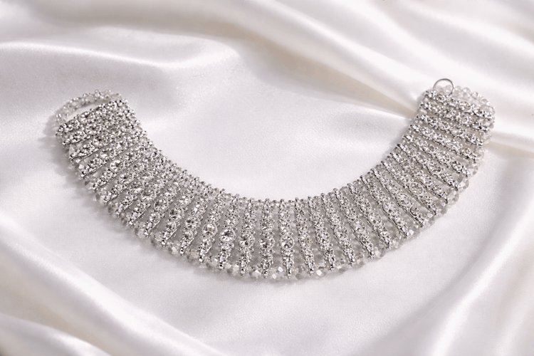 Silver necklace on a satin background