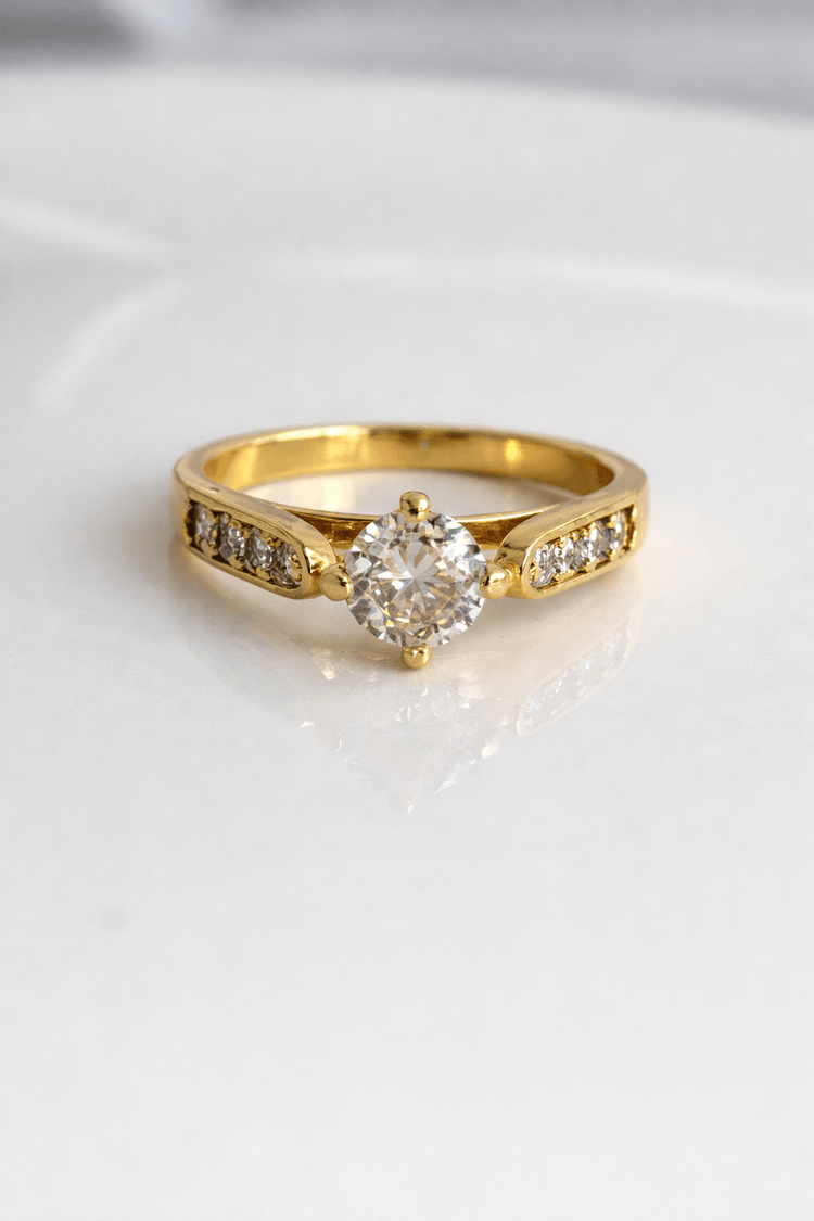 Gold ring with a diamond on a white background