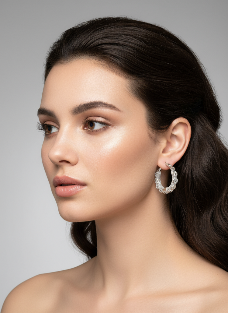 Pair of silver hoop earrings on a gray background