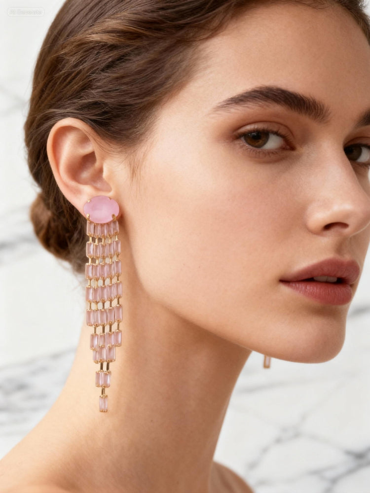 Close-up of a woman wearing pink beaded earrings with a neutral background